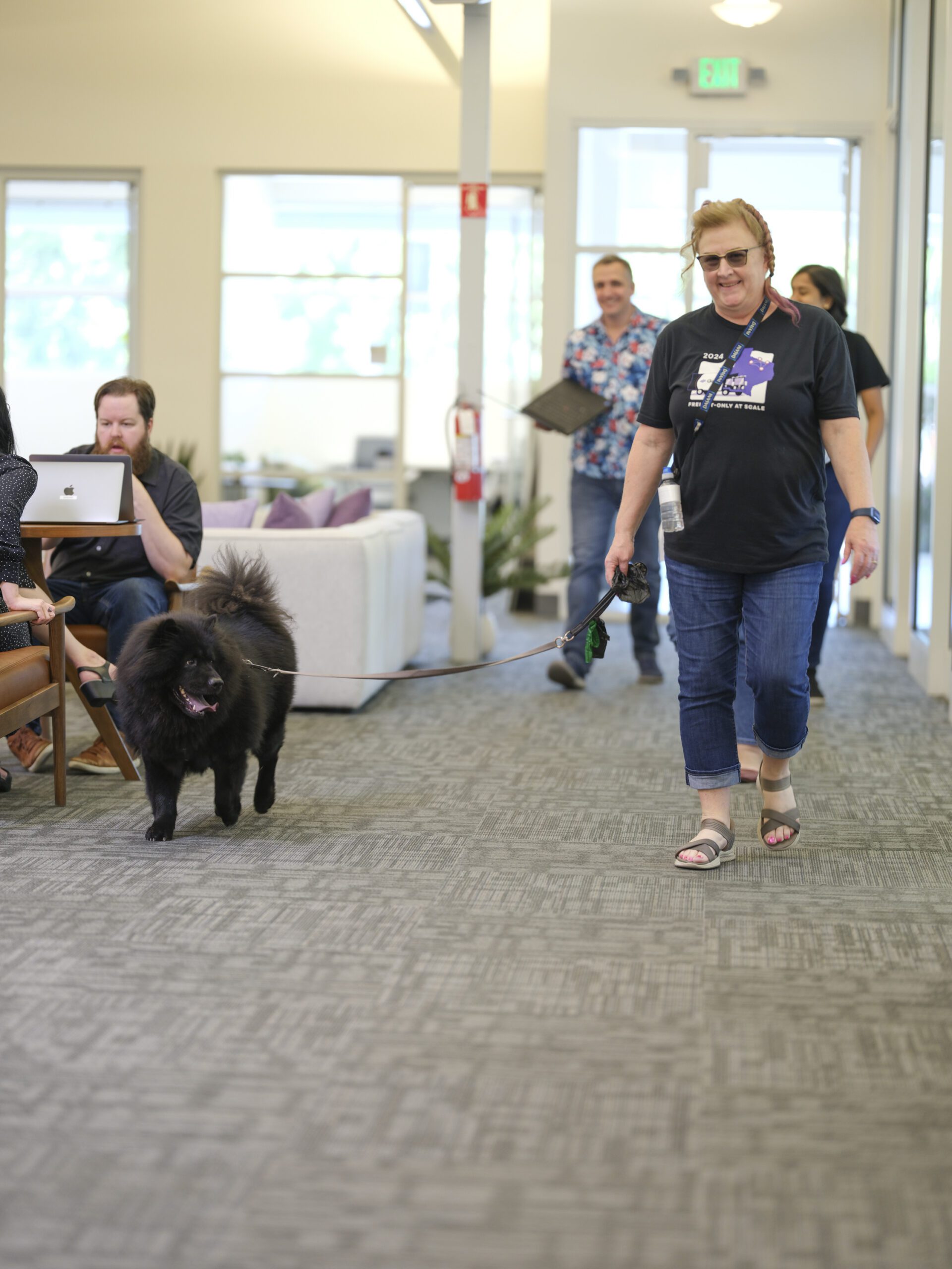 Employee with dog walking through office